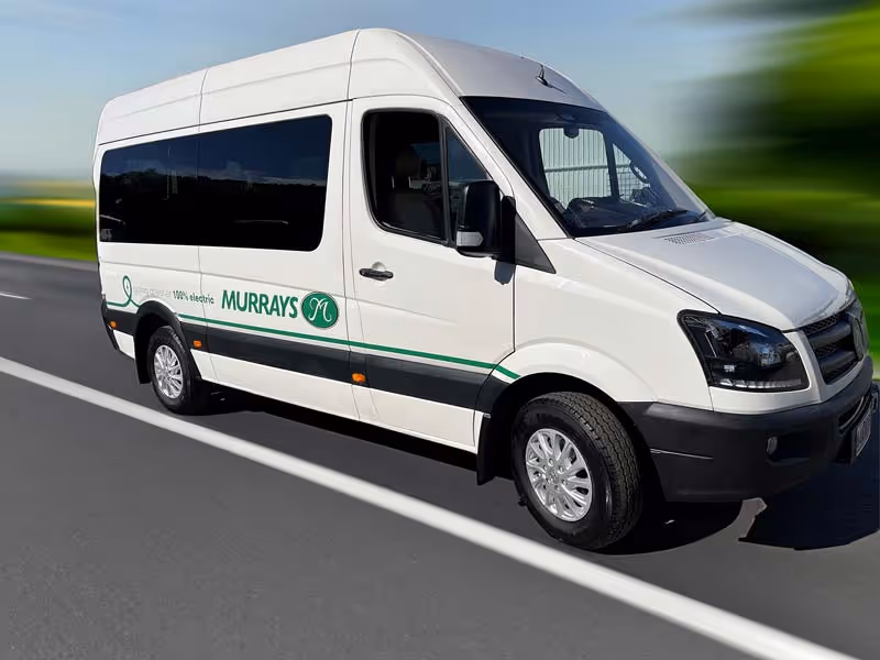 Image of a Murrays Electric Vehicle driving on the road.